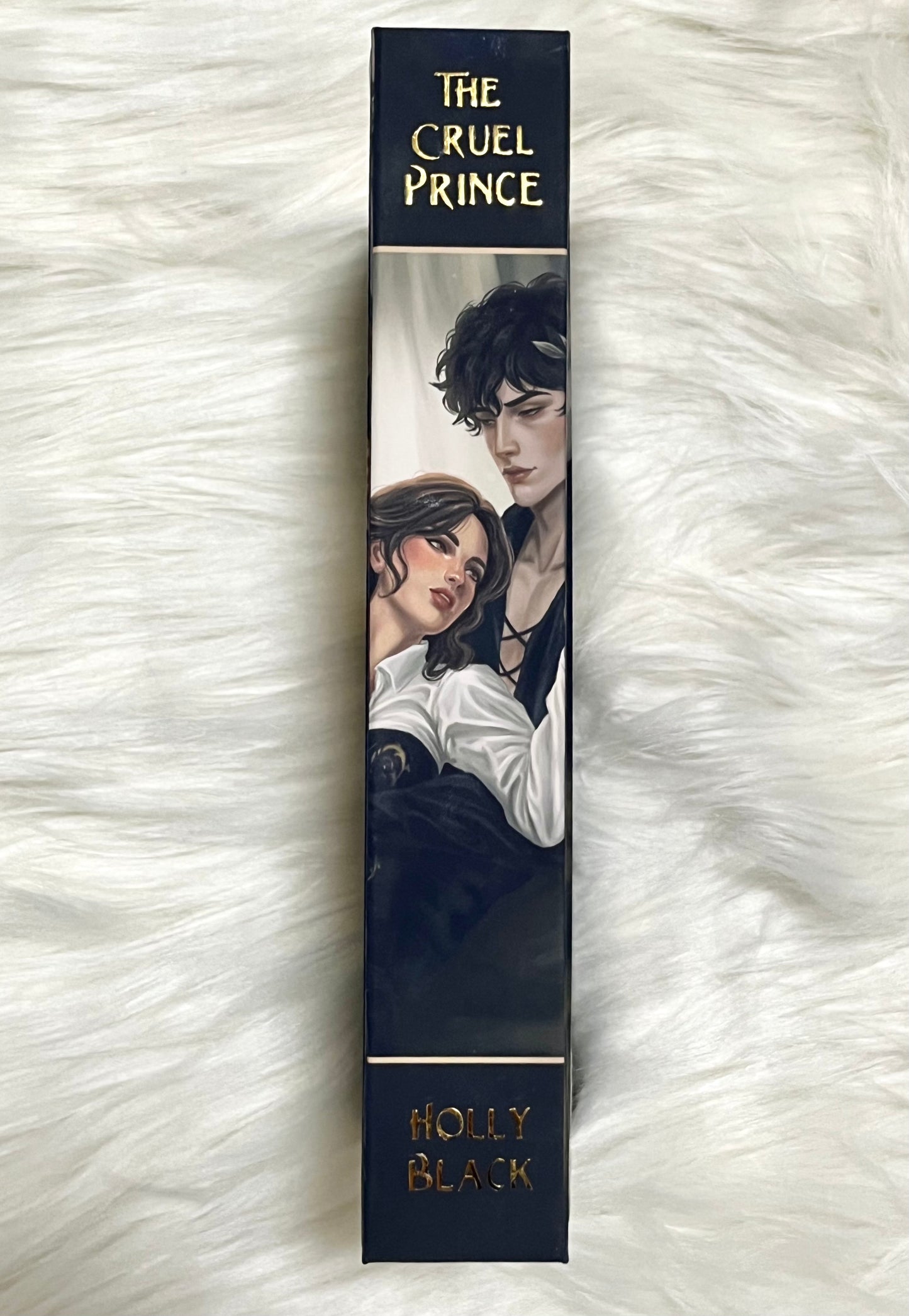 Bookend with illustration of two characters and 'The Cruel Prince' by Holly Black on a white fluffy background