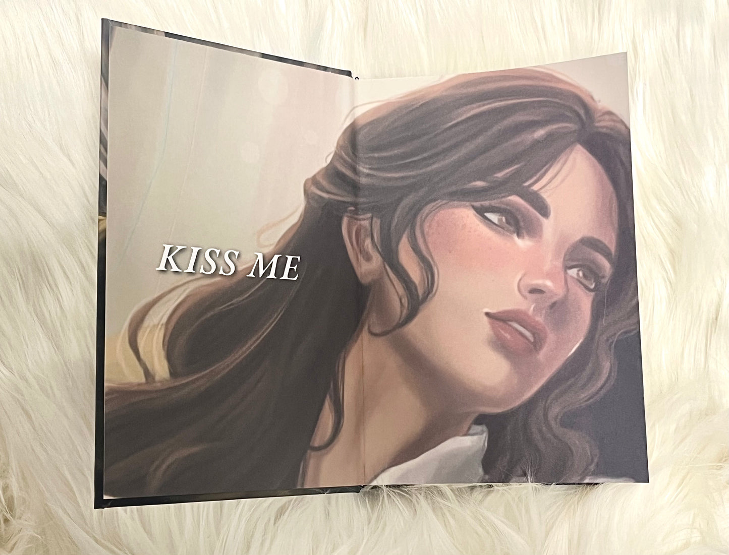 Illustration of a woman's face with 'KISS ME' text on a textured surface