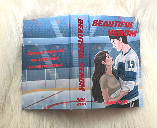 Book titled 'Beautiful Venom' by Rina Kent on a light background