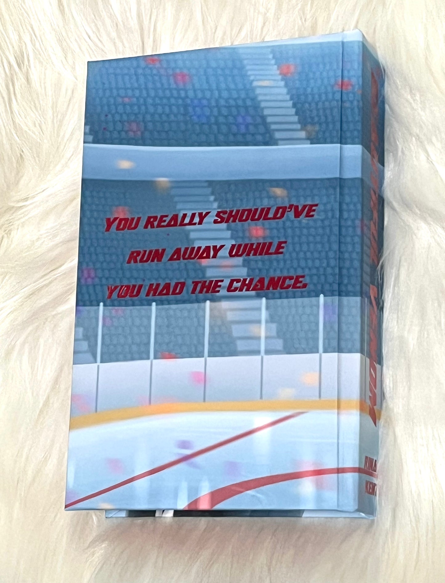 Book with a quote on the cover, placed on a textured surface