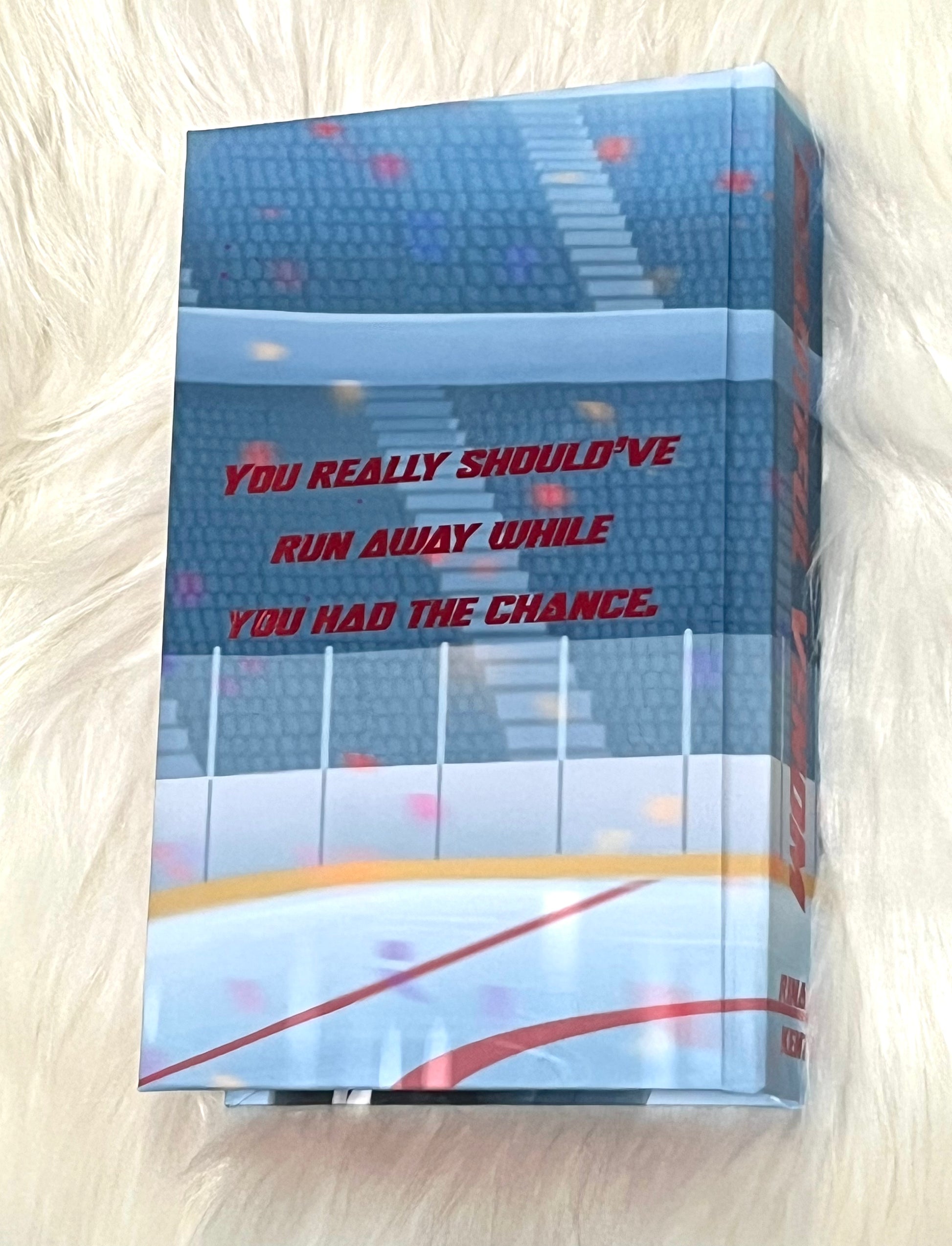 Book with a quote on the cover, placed on a textured surface