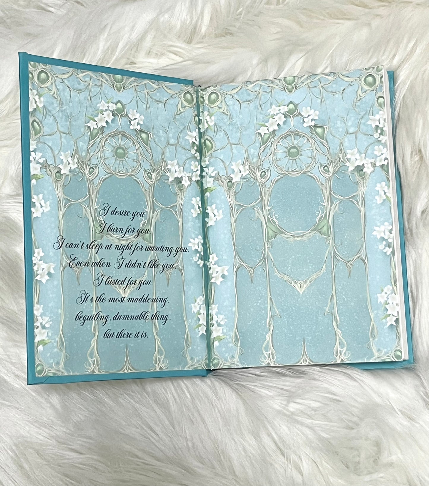 Open card with decorative design and text on a white fluffy background
