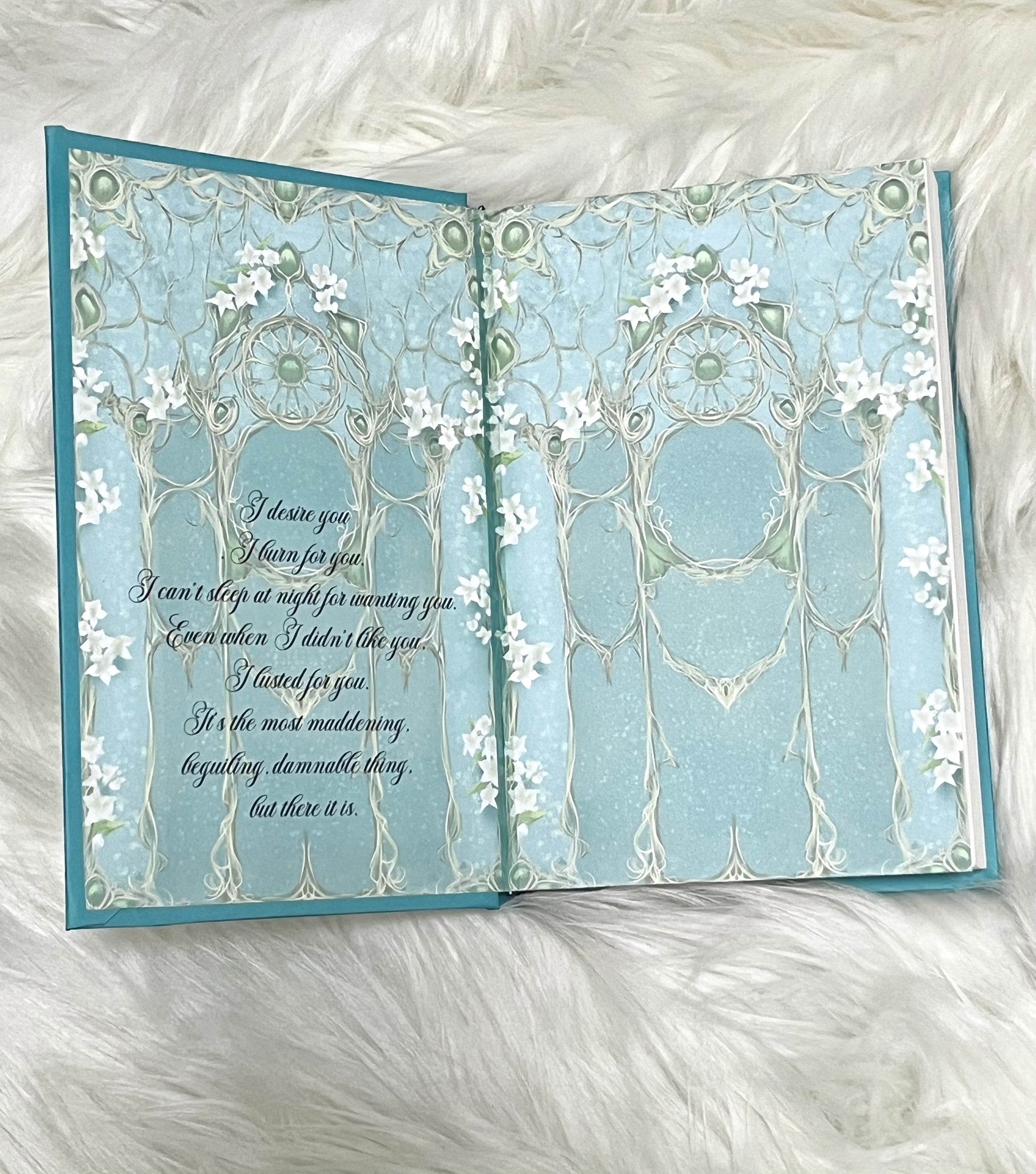 Open card with decorative design and text on a white fluffy background